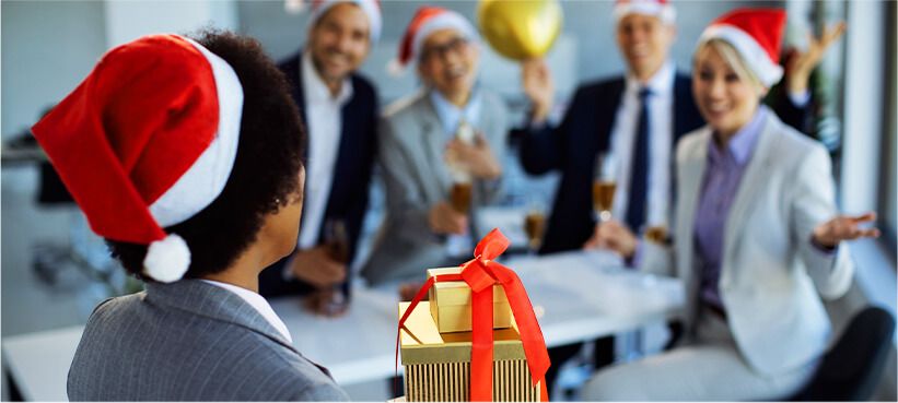 Employee bringing in holiday gift to corporate holiday party.